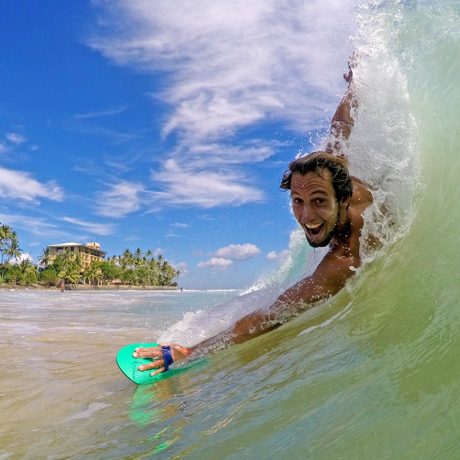 Rider smiling after a wave with an AHUA handplane